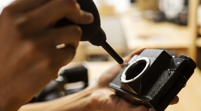 side-view-hands-repairing-photo-camera